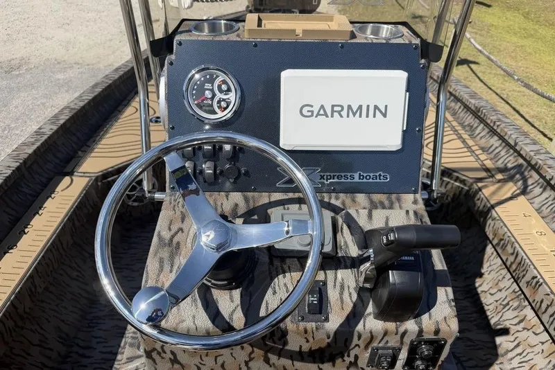Slide: The Image of Steering console of 2026 Xpress H22B Bay boat with Garmin navigation system. - 12