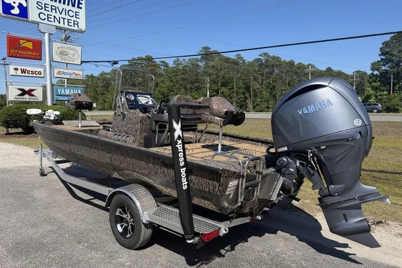 Slide: The Image of 2026 Xpress H22B Bay boat with Yamaha engine at marine service center. - 5
