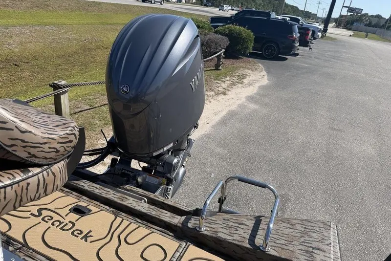 Slide: The Image of 2026 Xpress H22B Bay boat with Yamaha outboard motor and SeaDek flooring in parking lot. - 9