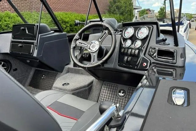 Slide: The Image of 2025 Tracker Targa V-19 WT Tournament Edition boat interior with steering wheel and dashboard controls. - 6