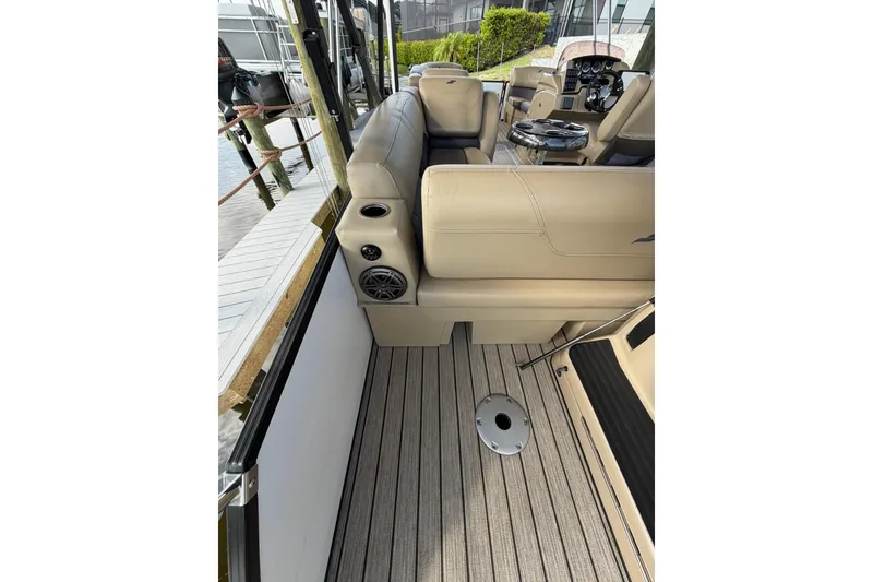 Slide: The Image of 2022 Starcraft CX 25 DL BAR boat interior with beige seating and striped flooring. - 13