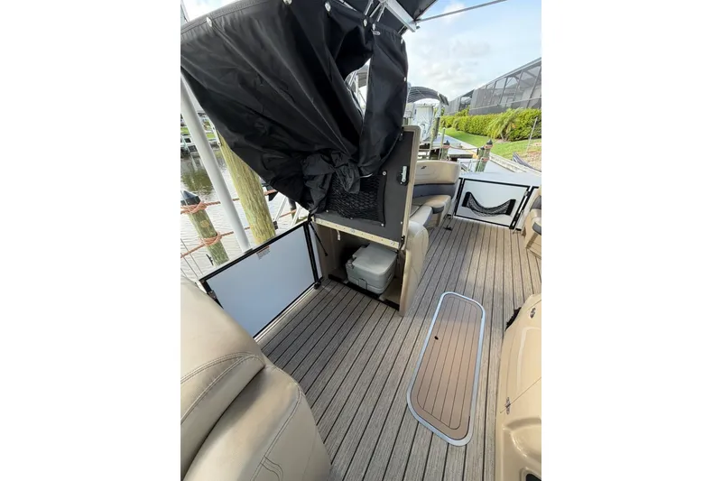 Slide: The Image of 2022 Starcraft CX 25 DL BAR boat interior with seating and storage compartments. - 14