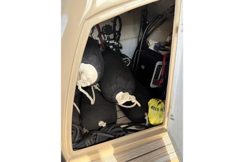Slide: The Image of Storage compartment of 2022 Starcraft CX 25 DL BAR boat with ropes and equipment. - 19