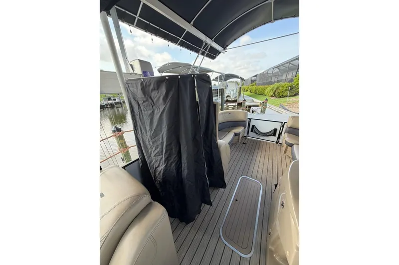 Slide: The Image of 2022 Starcraft CX 25 DL BAR pontoon boat interior with seating and privacy curtain. - 20