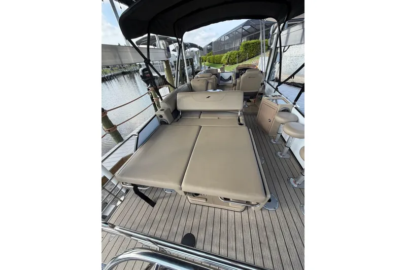 Slide: The Image of 2022 Starcraft CX 25 DL BAR boat interior with beige seating and sleek design. - 9