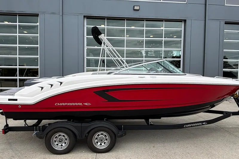 The Image of 2021 Chaparral 23 SSi boat with red and white exterior on a trailer. - 1
