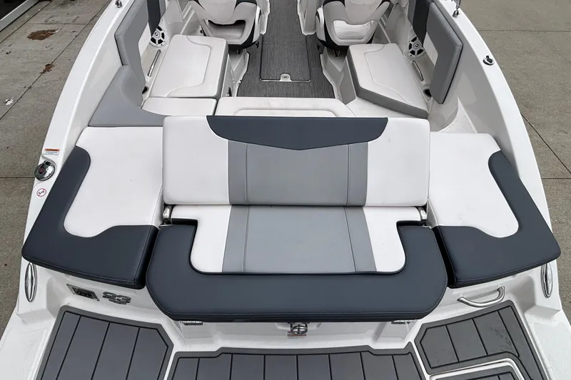 Slide: The Image of 2021 Chaparral 23 SSi boat interior with gray and white seating arrangement. - 13