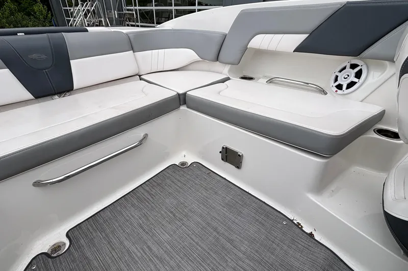Slide: The Image of 2021 Chaparral 23 SSi boat interior with gray and white seating and speaker. - 17