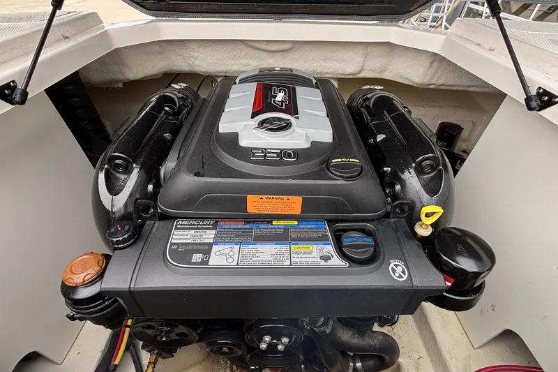Slide: The Image of Engine compartment of a 2021 Chaparral 23 SSi boat, featuring a Mercury engine. - 20