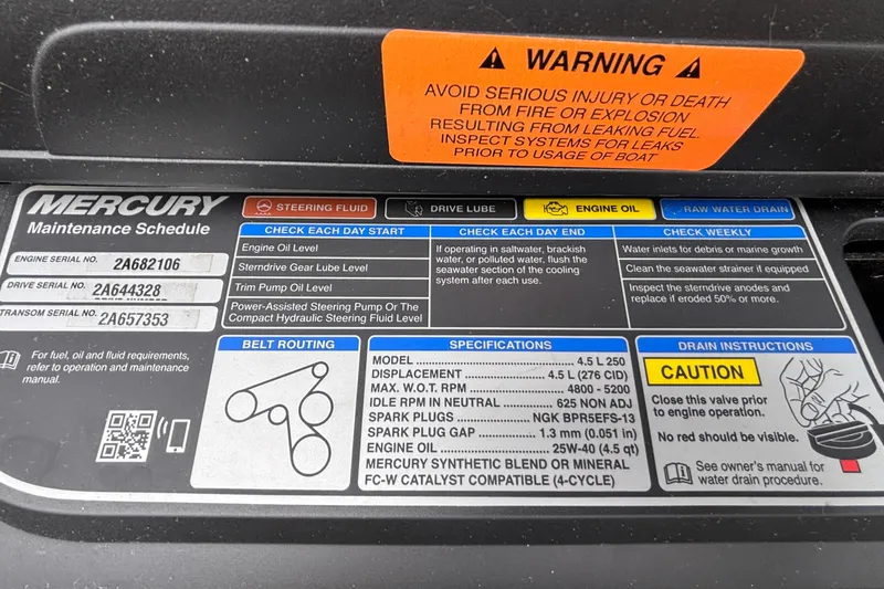 Slide: The Image of Warning and maintenance labels on a 2021 Chaparral 23 SSi boat engine. - 21