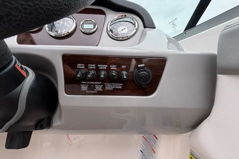 Slide: The Image of Dashboard controls of a 2021 Chaparral 23 SSi boat with gauges and switches. - 27