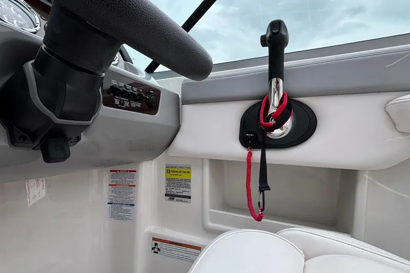 Slide: The Image of 2021 Chaparral 23 SSi boat cockpit with steering wheel and throttle controls. - 29