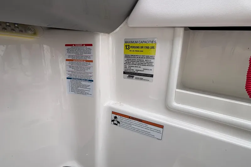Slide: The Image of 2021 Chaparral 23 SSi boat capacity labels, indicating maximum of 13 persons or 1765 lbs. - 30