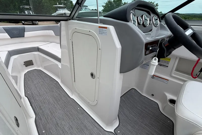 Slide: The Image of Interior view of 2021 Chaparral 23 SSi boat, featuring sleek dashboard and seating. - 32