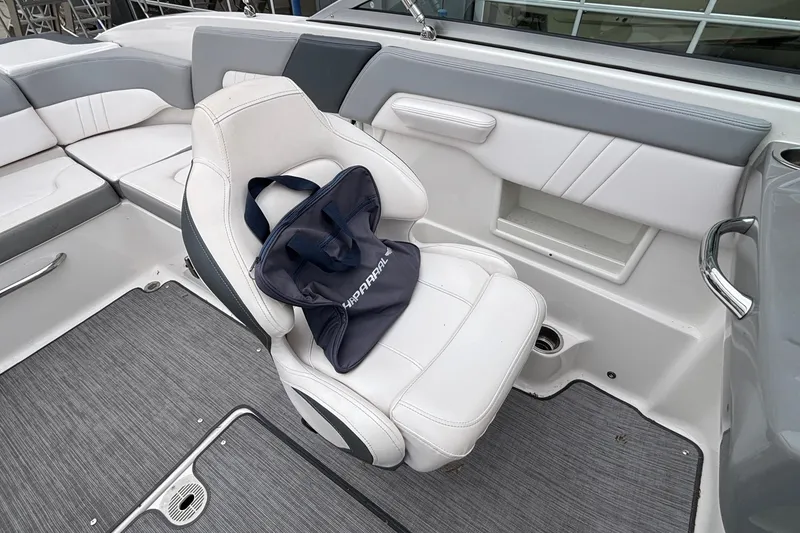 Slide: The Image of 2021 Chaparral 23 SSi boat interior with white seating and branded bag. - 35