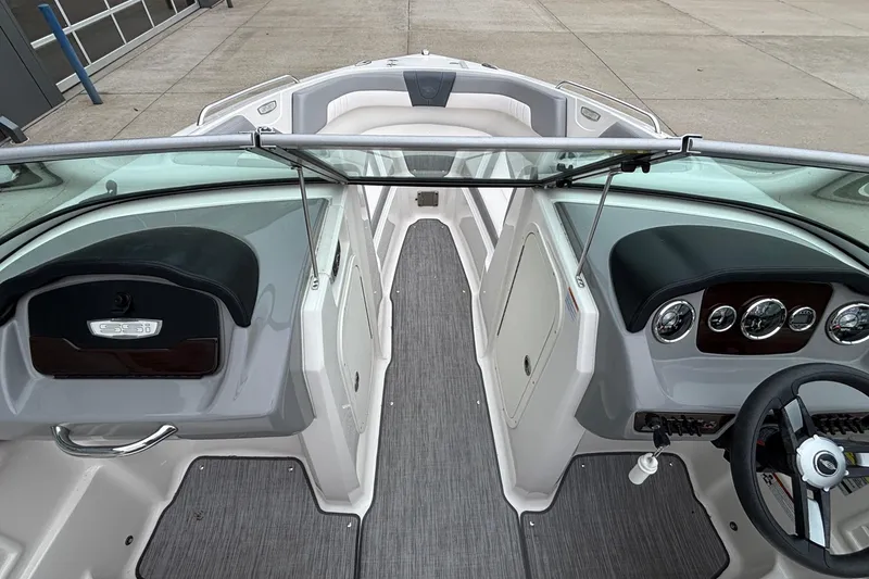Slide: The Image of Interior view of 2021 Chaparral 23 SSi boat, featuring sleek dashboard and seating. - 36