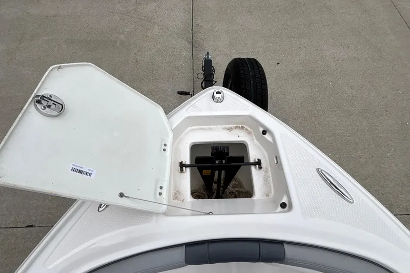 Slide: The Image of Open storage compartment on 2021 Chaparral 23 SSi boat, showing anchor and rope. - 41