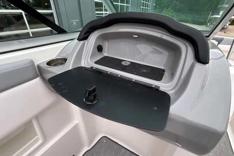 Slide: The Image of 2021 Chaparral 23 SSi boat interior with storage compartment and cup holder. - 44