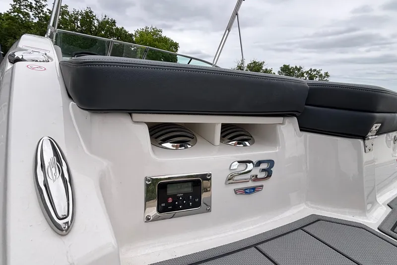 Slide: The Image of 2021 Chaparral 23 SSi boat interior with sleek seating and control panel. - 7