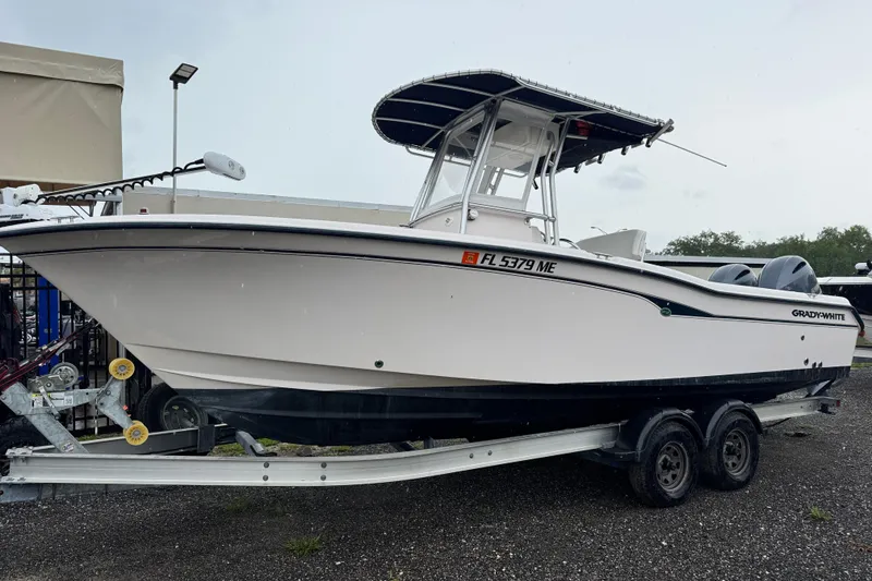 Slide: The Image of 2003 Grady-White Advance 257 boat on trailer, side view, parked outdoors. - 1