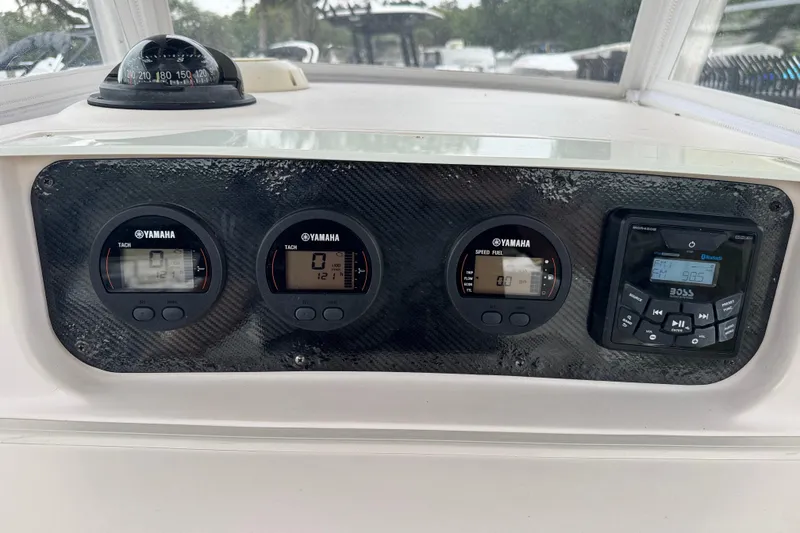 Slide: The Image of Dashboard of 2003 Grady-White Advance 257 boat with Yamaha gauges and Boss audio system. - 11