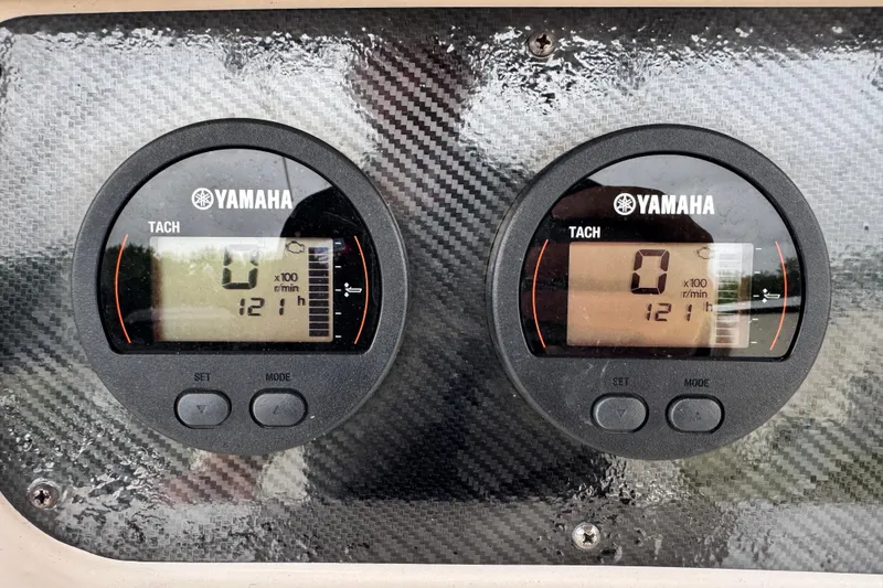 Slide: The Image of Yamaha tachometers on a 2003 Grady-White Advance 257 boat dashboard, displaying zero RPM. - 12