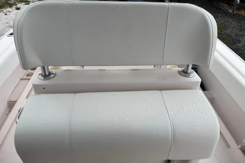 Slide: The Image of White cushioned seating on a 2003 Grady-White Advance 257 boat, with water droplets. - 15