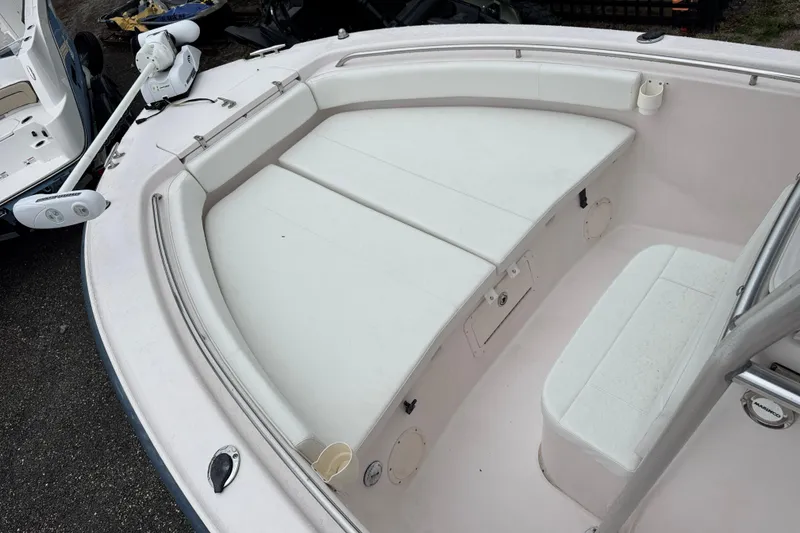 Slide: The Image of 2003 Grady-White Advance 257 boat interior with cushioned seating and trolling motor. - 16