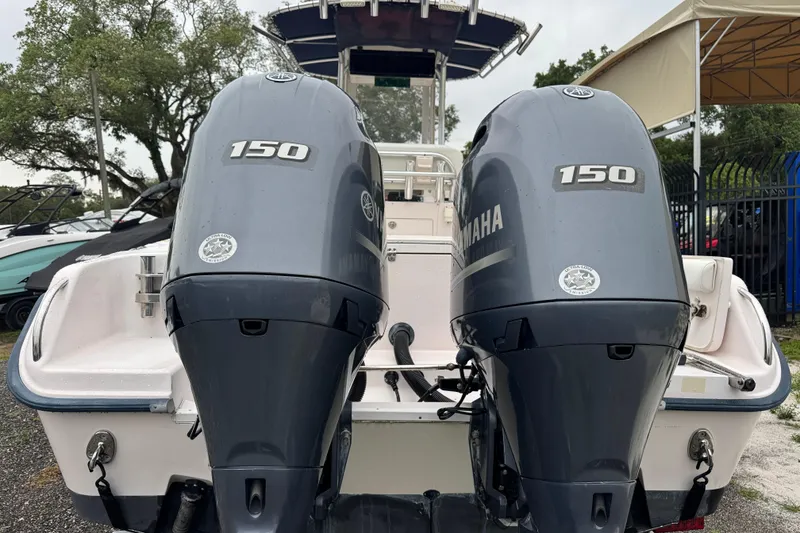 Slide: The Image of 2003 Grady-White Advance 257 boat with dual Yamaha 150 engines, parked outdoors. - 2