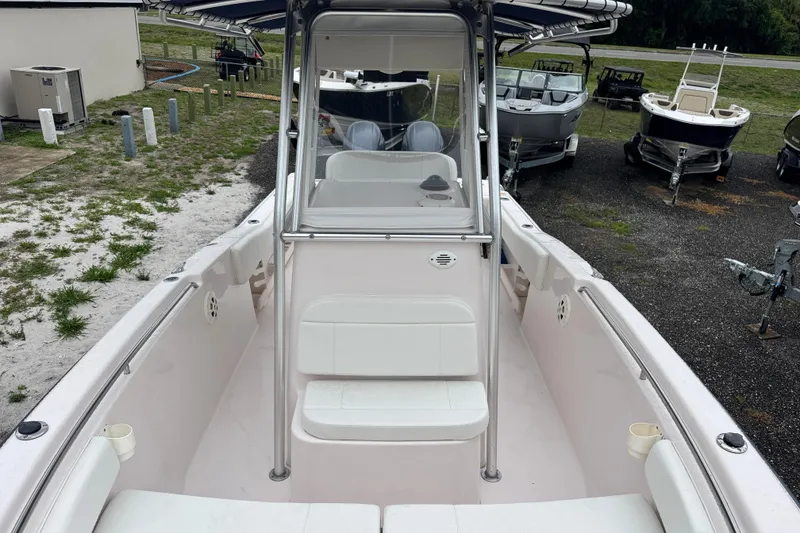 Slide: The Image of 2003 Grady-White Advance 257 boat interior with seating and console, parked outdoors. - 21