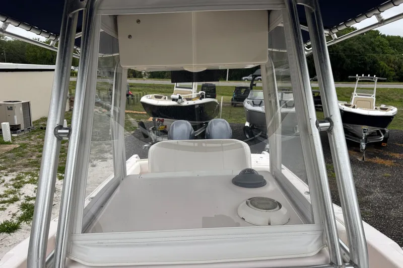 Slide: The Image of 2003 Grady-White Advance 257 boat interior with clear enclosure and helm view. - 23