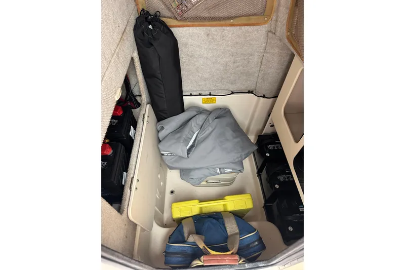 Slide: The Image of Storage compartment of a 2003 Grady-White Advance 257 boat with gear and equipment. - 24
