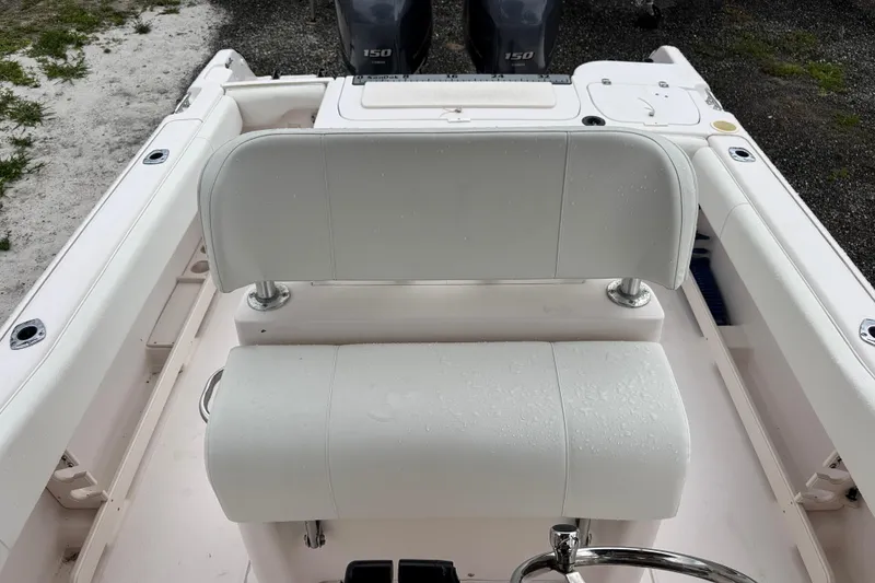 Slide: The Image of 2003 Grady-White Advance 257 boat interior with white seating and dual engines. - 25
