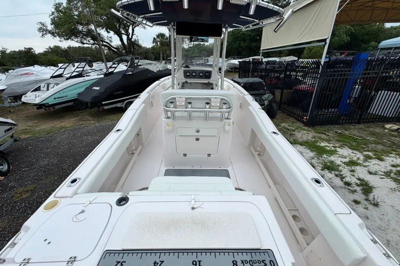 Slide: The Image of 2003 Grady-White Advance 257 boat interior, showcasing helm and seating area in a marina setting. - 3