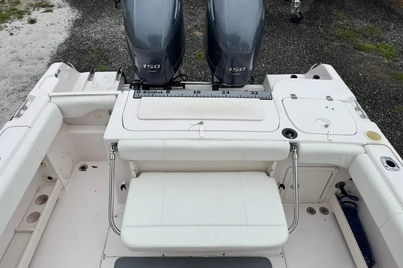 Slide: The Image of 2003 Grady-White Advance 257 boat interior with dual 150 horsepower engines. - 7