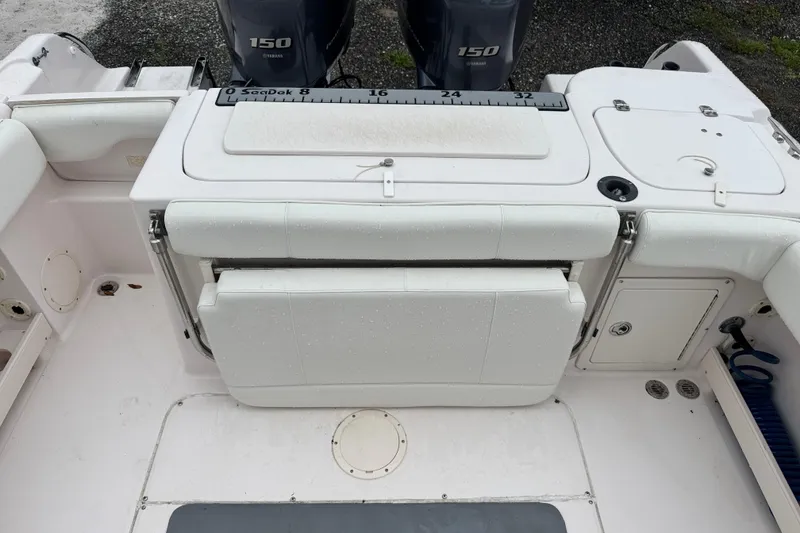 Slide: The Image of 2003 Grady-White Advance 257 boat interior with Yamaha 150 engines and seating area. - 8