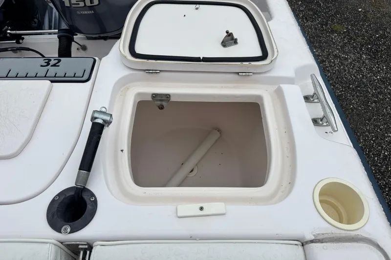 Slide: The Image of 2003 Grady-White Advance 257 boat deck with storage compartment and Yamaha 150 engine. - 9