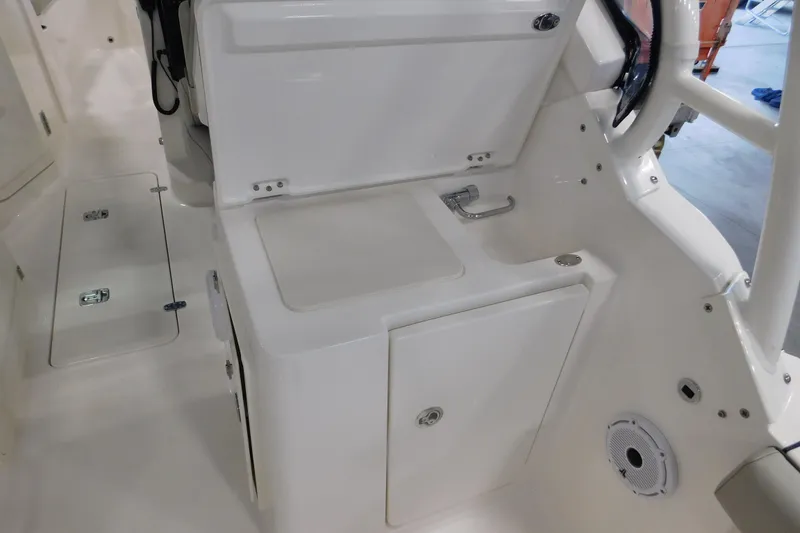 Slide: The Image of 2022 Pursuit DC 266 Dual Console interior with storage compartments and sleek design. - 17