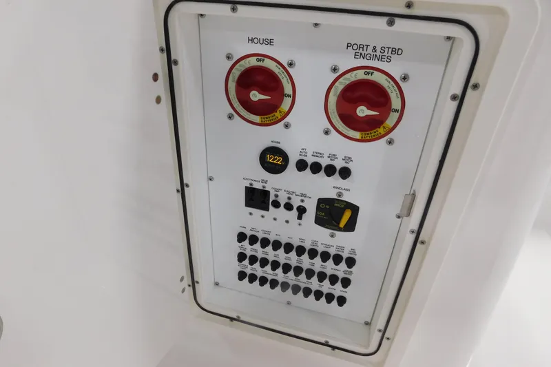 Slide: The Image of Electrical panel of 2022 Pursuit DC 266 Dual Console boat with switches and controls. - 25