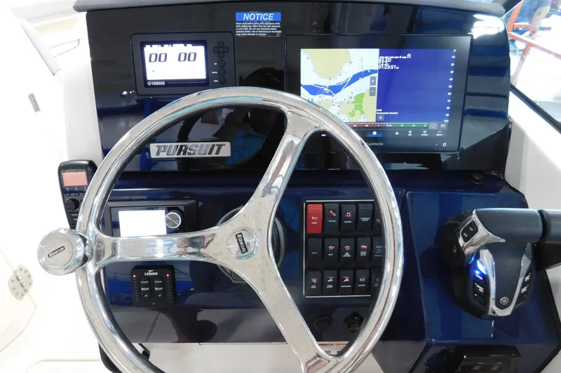 Slide: The Image of 2022 Pursuit DC 266 Dual Console dashboard with steering wheel and navigation controls. - 28