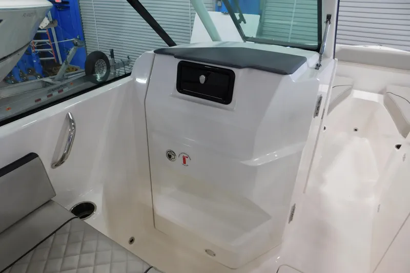 Slide: The Image of 2022 Pursuit DC 266 Dual Console interior with seating and storage compartment. - 36