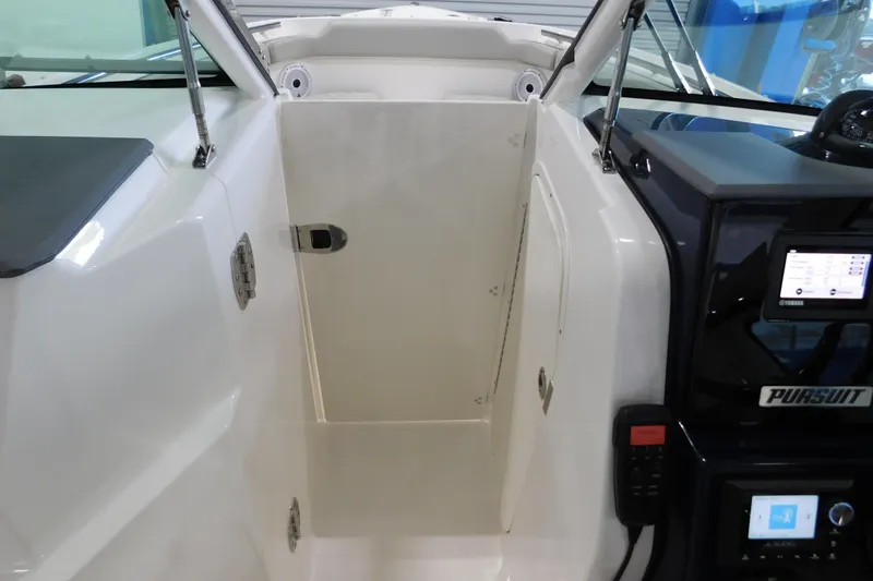 Slide: The Image of 2022 Pursuit DC 266 Dual Console interior with dashboard and storage compartment. - 40