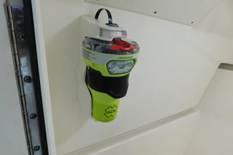 Slide: The Image of Emergency beacon mounted on a 2022 Pursuit DC 266 Dual Console boat interior. - 42