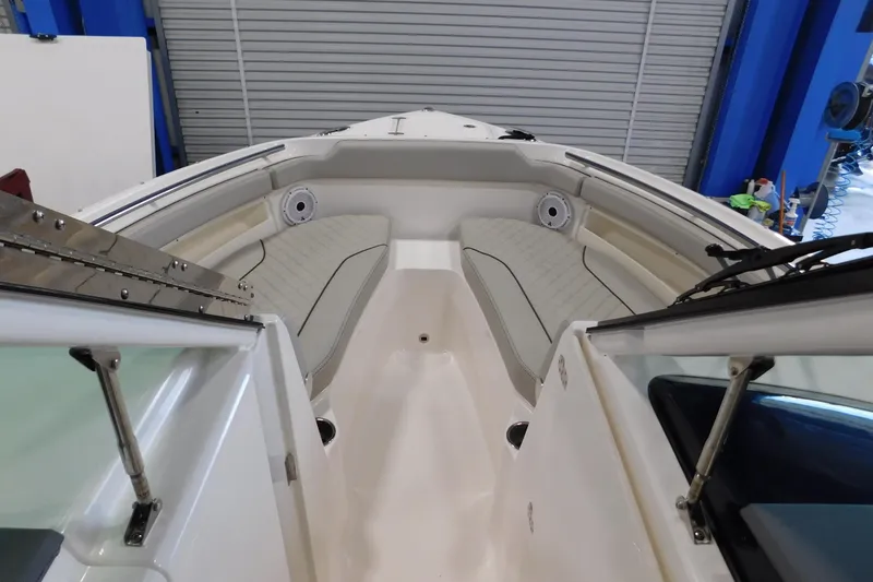 Slide: The Image of 2022 Pursuit DC 266 Dual Console boat interior with cushioned seating and speakers. - 44