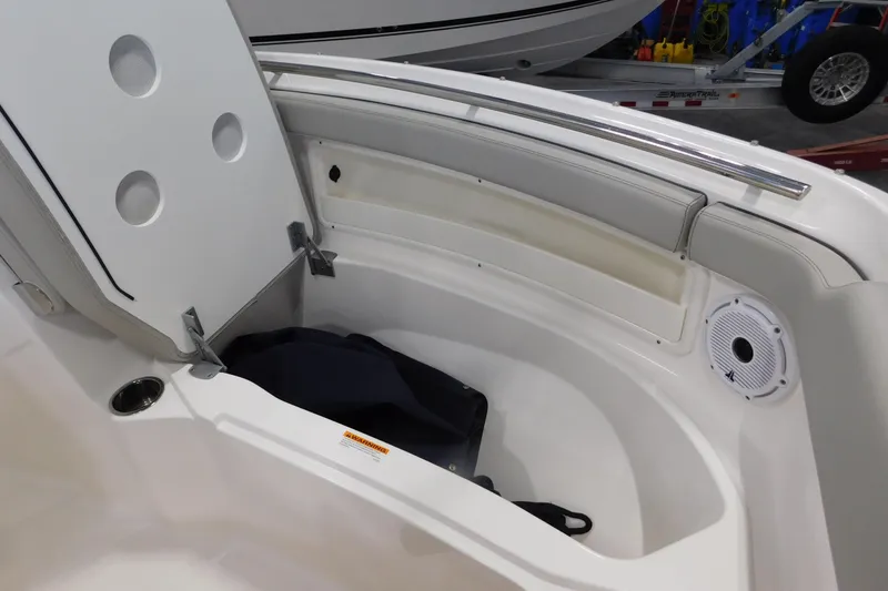 Slide: The Image of 2022 Pursuit DC 266 Dual Console boat interior storage compartment with speaker. - 46