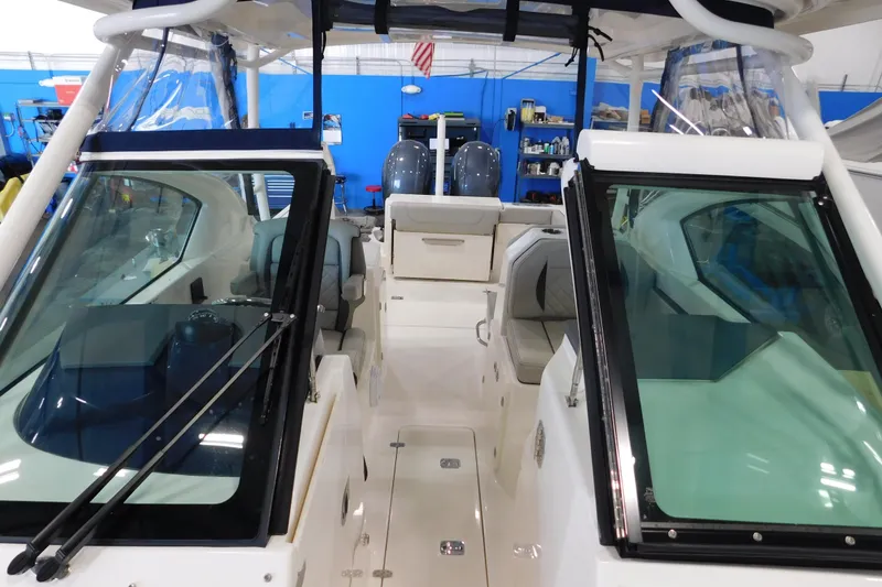 Slide: The Image of 2022 Pursuit DC 266 Dual Console boat interior with seating and windshield. - 49