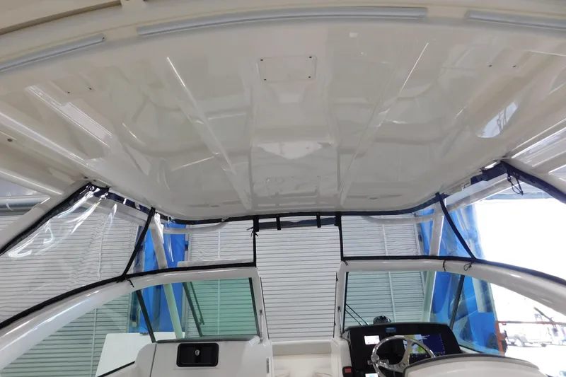 Slide: The Image of 2022 Pursuit DC 266 Dual Console boat interior with helm and windshield view. - 53