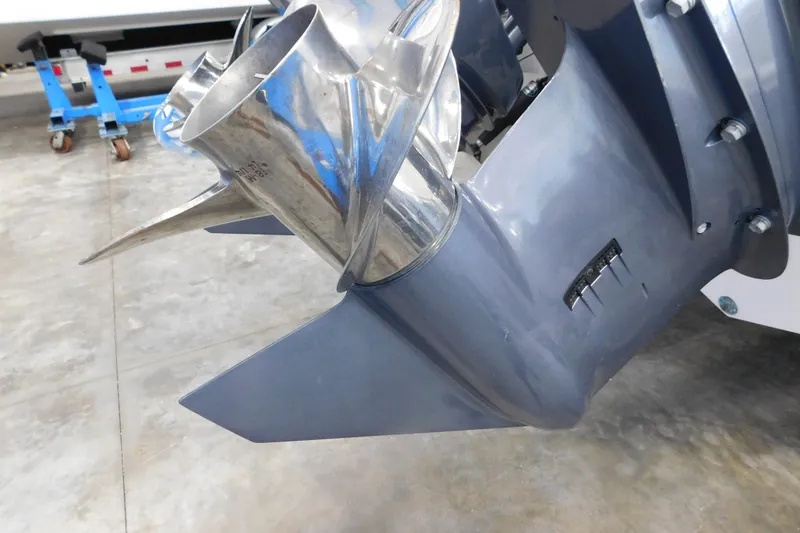 Slide: The Image of Close-up of a 2022 Pursuit DC 266 Dual Console boat propeller in a garage. - 8