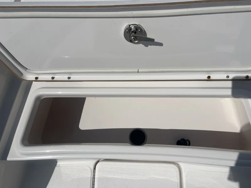 Slide: The Image of Open storage compartment on a 2017 Blue Wave 2300 boat. - 14