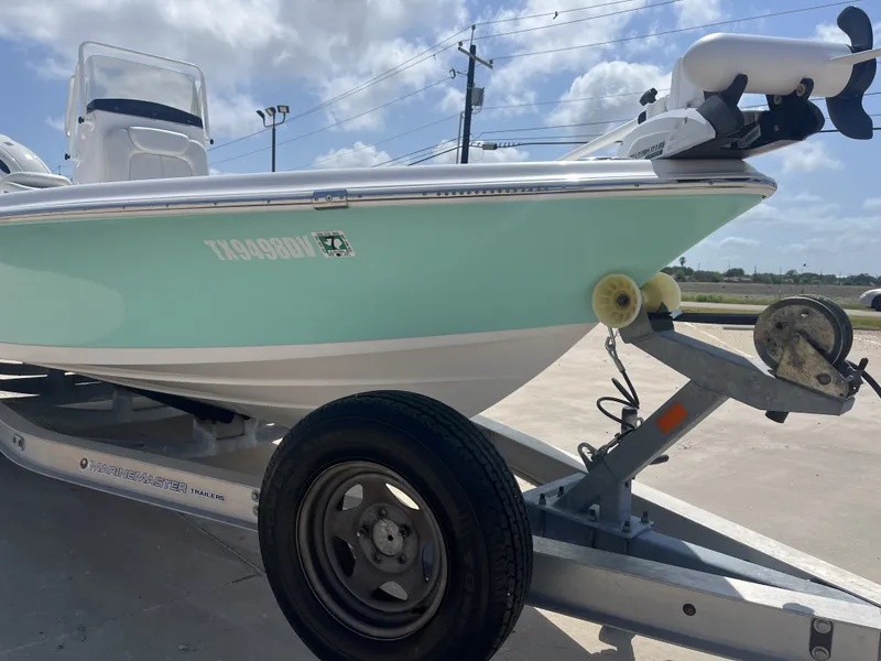 Slide: The Image of 2017 Blue Wave 2300 boat on trailer under sunny skies. - 6